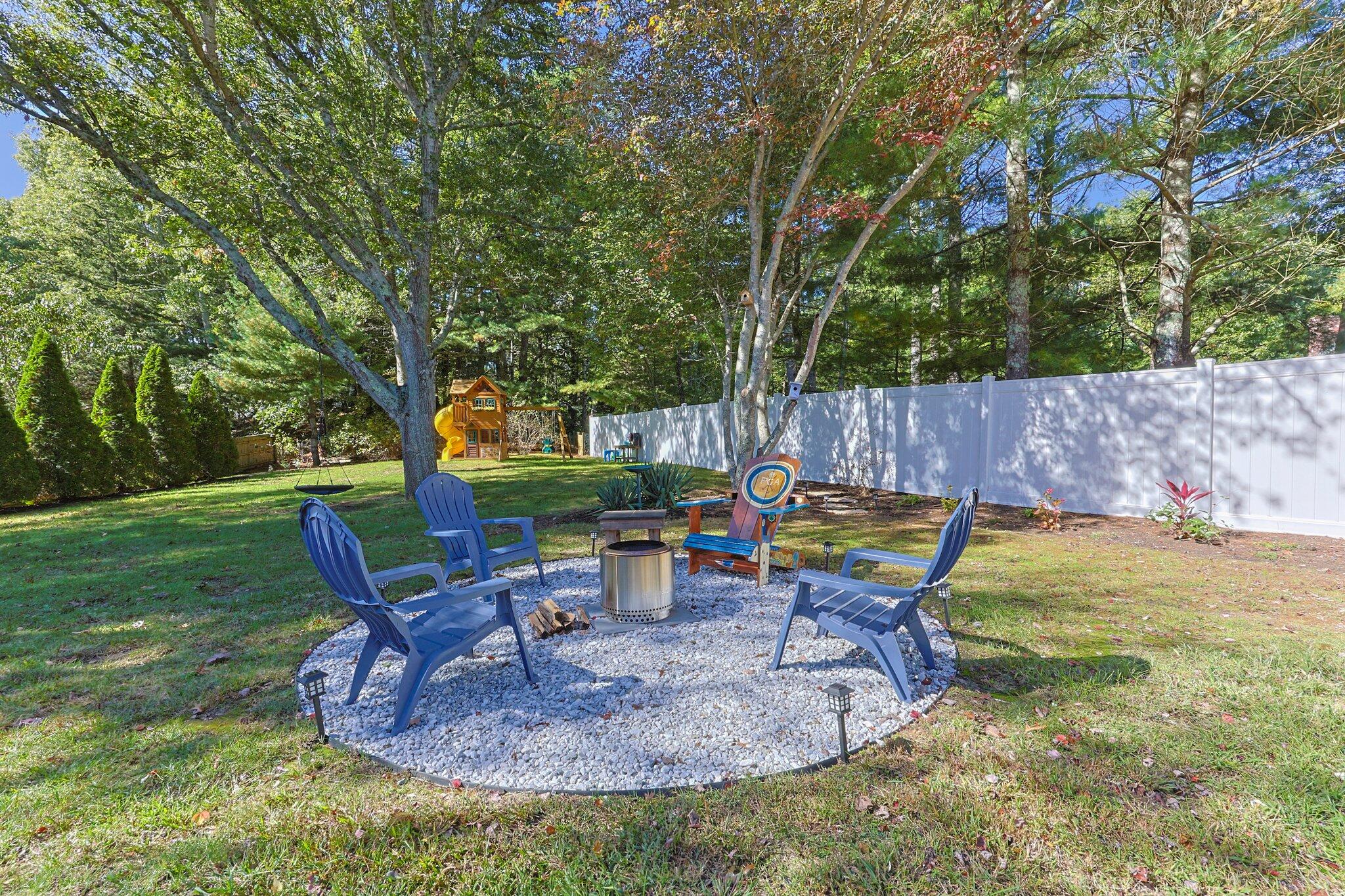 39 Maddaket Lane Centerville, MA 02632 - Photo 27 of 36 a backyard of a house with table and chairs