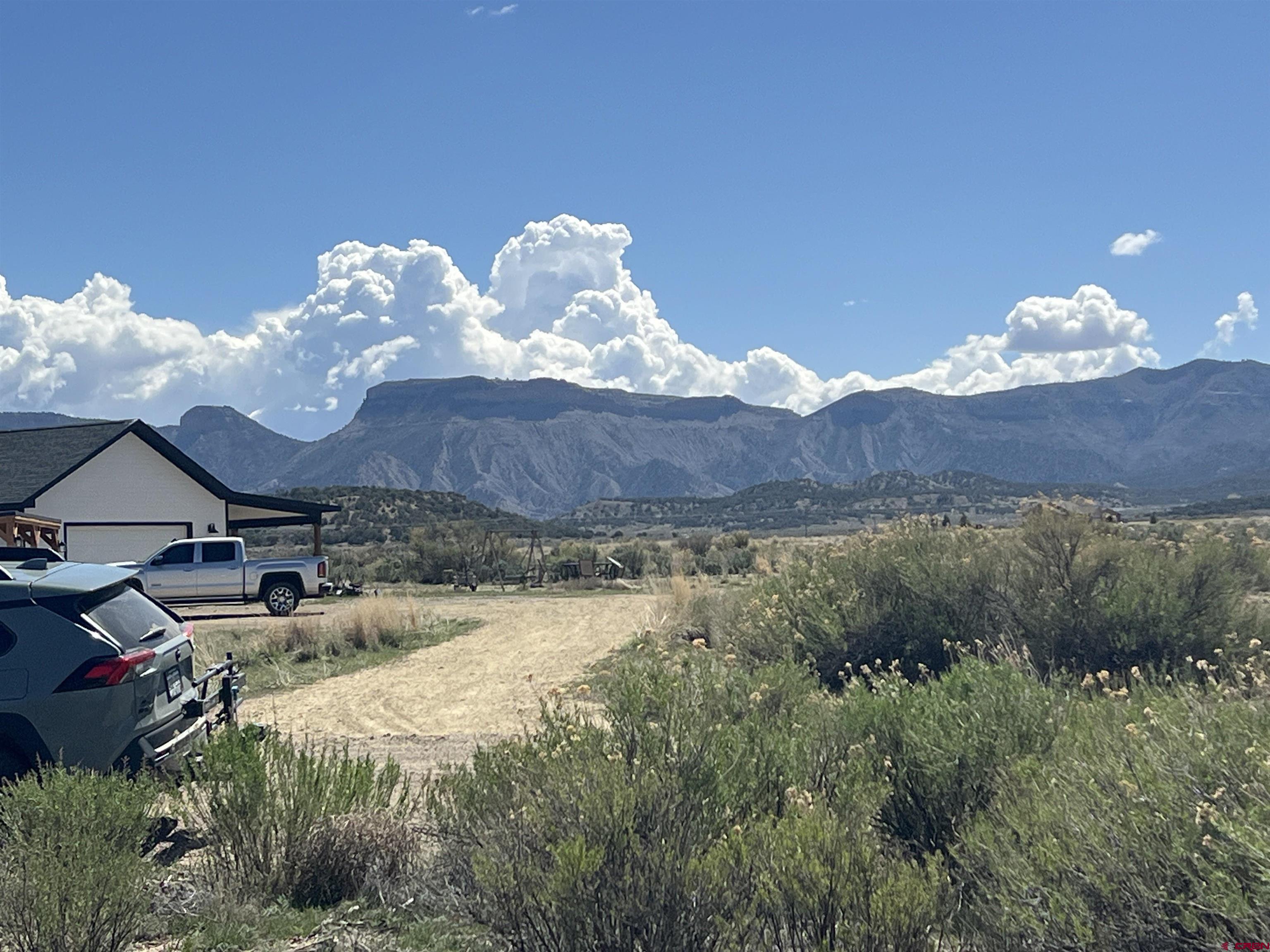 8385 Road 29.4 Loop Cortez, CO 81321 - Photo 7 of 8 a view of a house with yard and a lake view