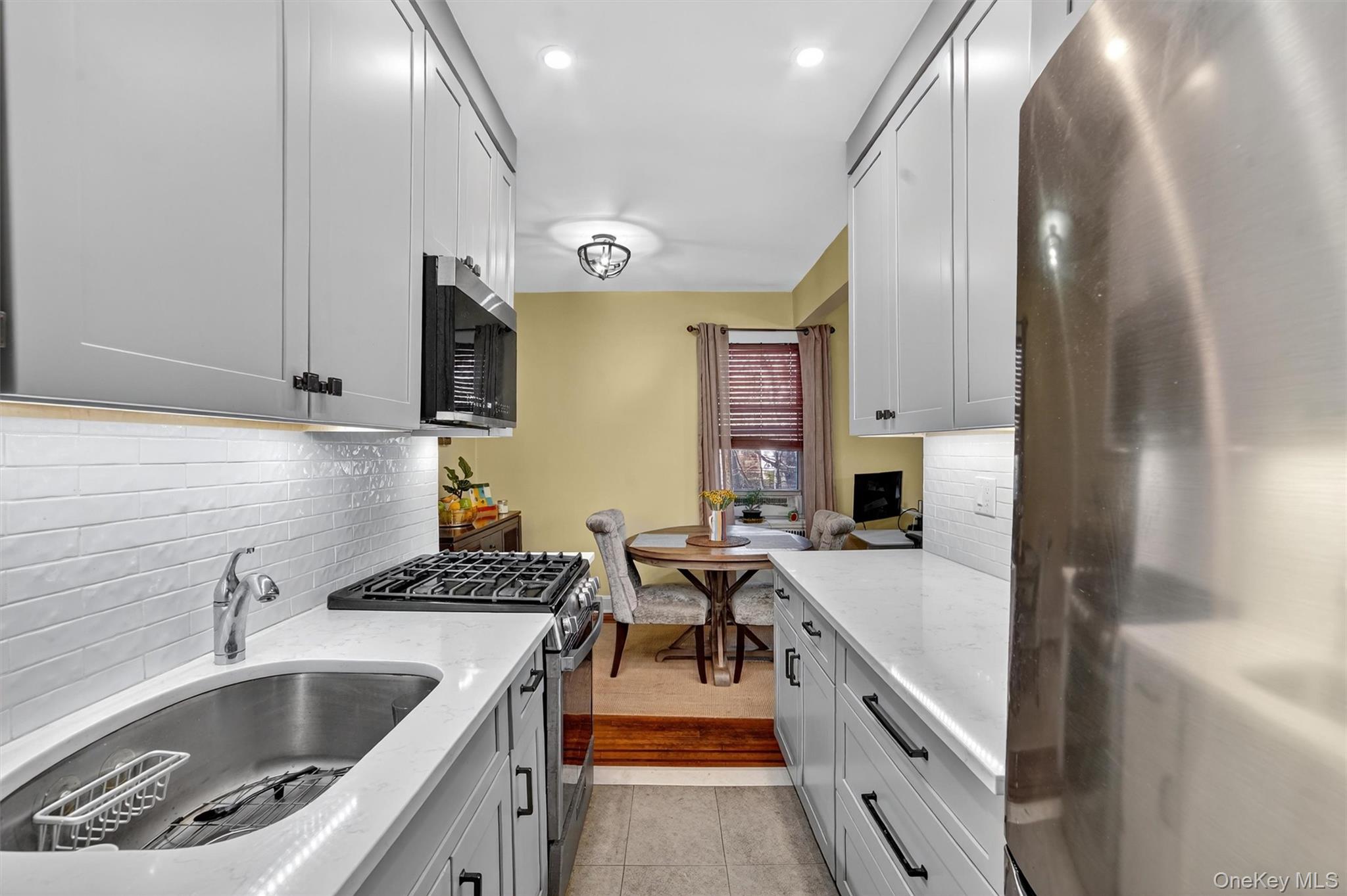 824 Palmer Road, Unit 2D Bronxville, NY 10708 - Photo 19 of 29 a kitchen that has a sink and a stove
