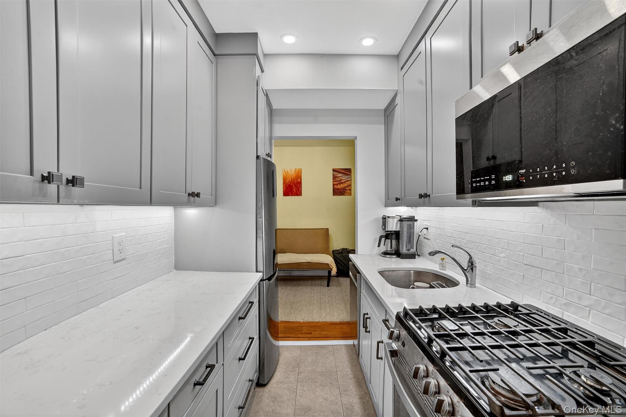 824 Palmer Road, Unit 2D Bronxville, NY 10708 - Photo 22 of 29 a kitchen with stainless steel appliances granite countertop a stove and a sink