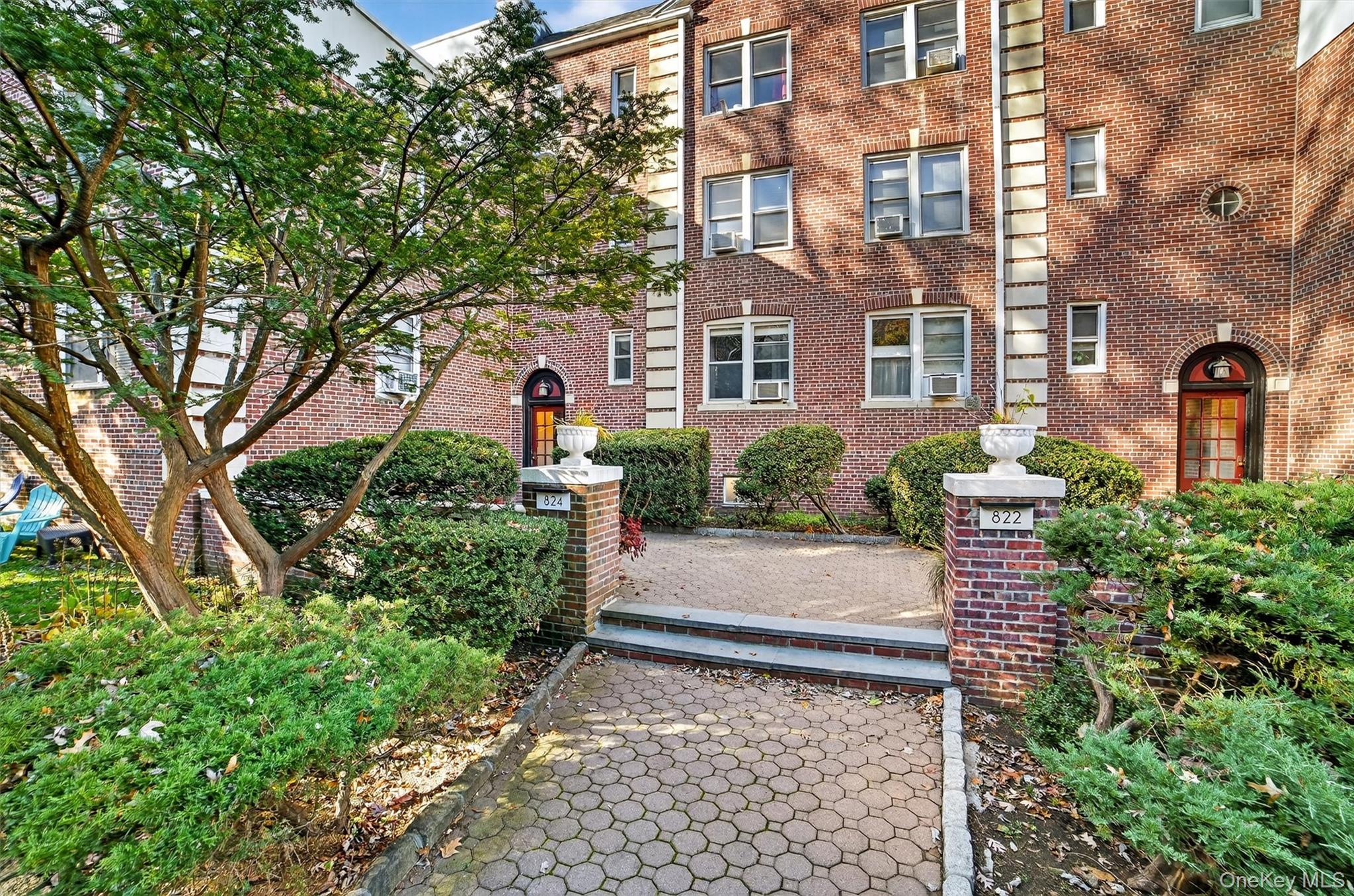 824 Palmer Road, Unit 2D Bronxville, NY 10708 - Photo 4 of 29 a front view of a house with a yard and fountain