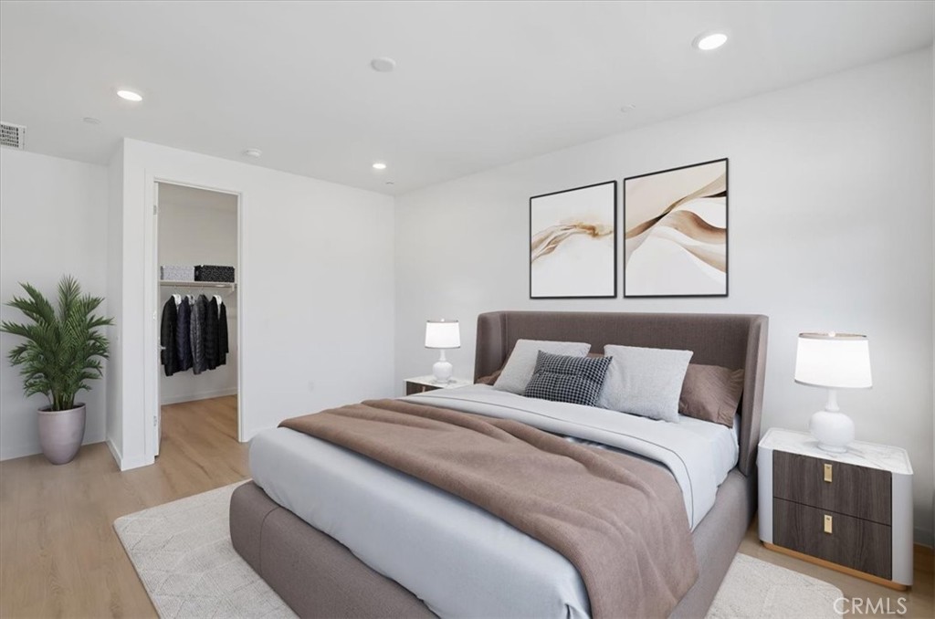 2378 Channel Drive, Unit 103 Ventura, CA 93003 - Photo 15 of 33 a bedroom with a bed and a potted plant