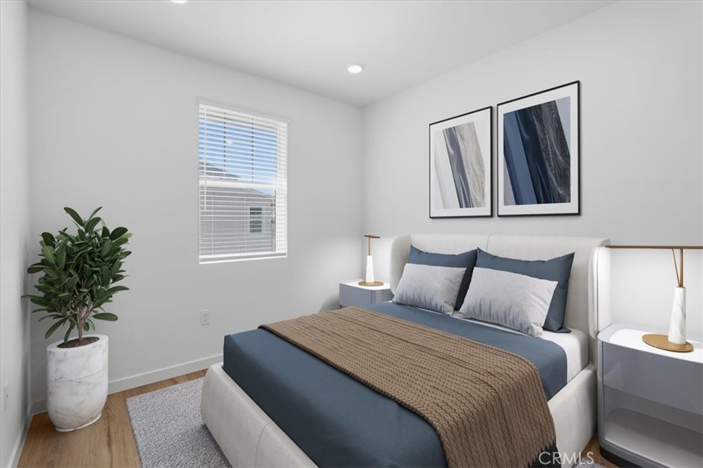 2378 Channel Drive, Unit 103 Ventura, CA 93003 - Photo 19 of 33 a bedroom with a bed and a potted plant