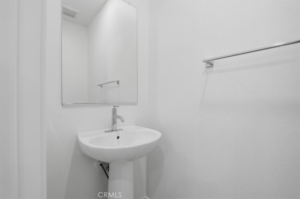 2378 Channel Drive, Unit 103 Ventura, CA 93003 - Photo 23 of 33 a bathroom with a sink and mirror