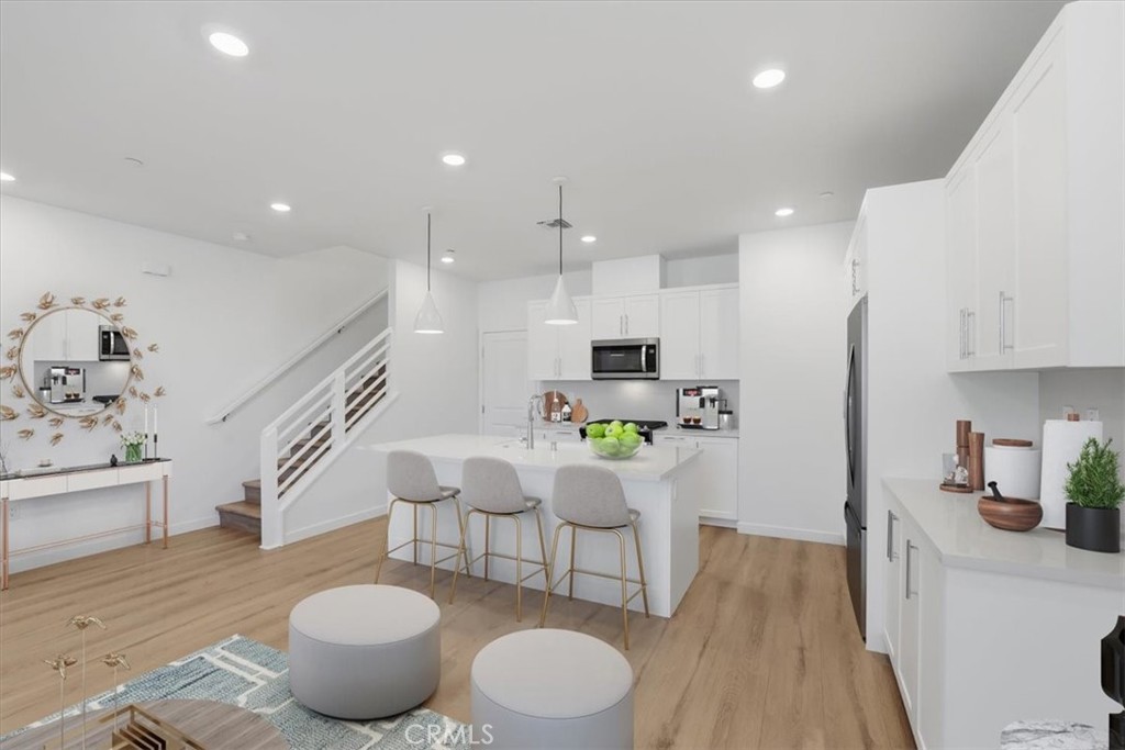 2378 Channel Drive, Unit 103 Ventura, CA 93003 - Photo 7 of 33 a kitchen with a table and chairs