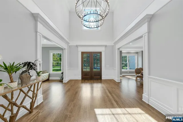 a view of a dining room with furniture wooden floor and chandelier