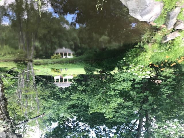 315 Thompsonville Road Monticello, NY 12701 - Photo 12 of 31 a backyard of a house with a yard and large trees