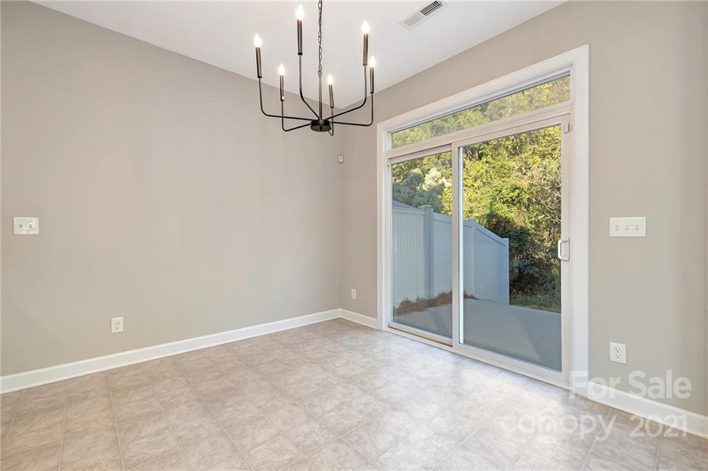 6931 Maricopa Road Charlotte, NC 28277 - Photo 14 of 31 en empty room with windows and outdoor view