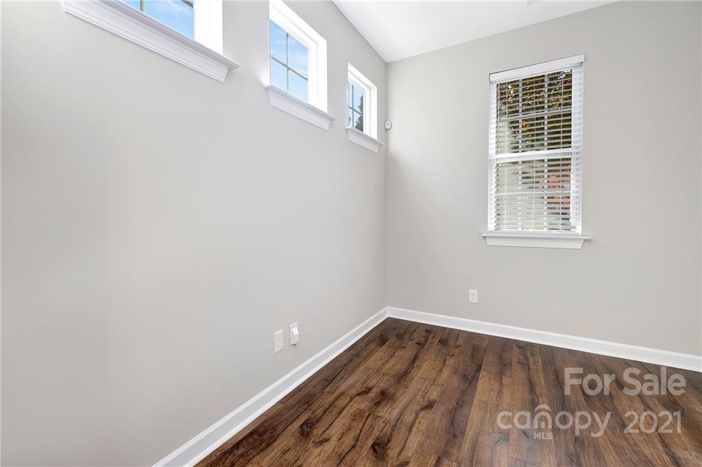 6931 Maricopa Road Charlotte, NC 28277 - Photo 16 of 31 a view of an empty room with wooden floor and a window
