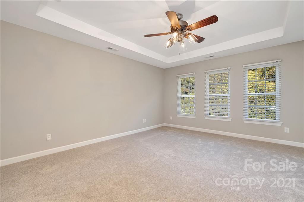 6931 Maricopa Road Charlotte, NC 28277 - Photo 17 of 31 an empty room with windows and ceiling fan
