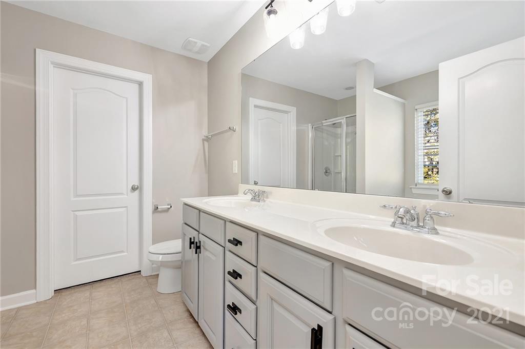 6931 Maricopa Road Charlotte, NC 28277 - Photo 19 of 31 a bathroom with a granite countertop sink and a mirror