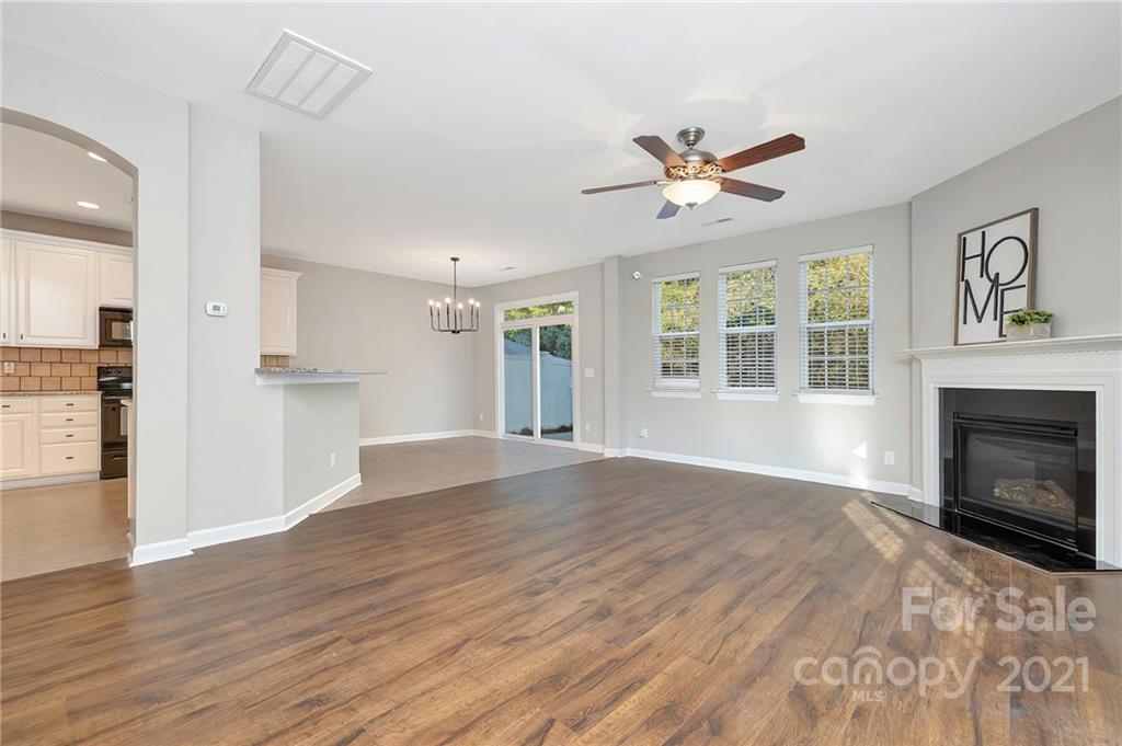 6931 Maricopa Road Charlotte, NC 28277 - Photo 5 of 31 a view of an empty room with window and wooden floor