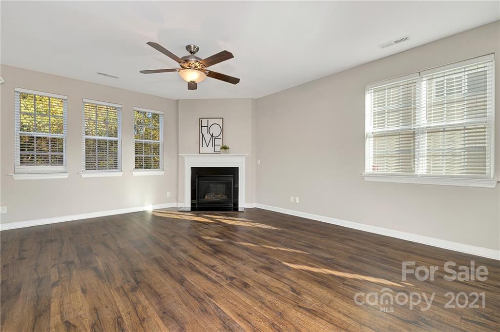 6931 Maricopa Road Charlotte, NC 28277 - Photo 7 of 31 a view of an empty room with wooden floor and a window