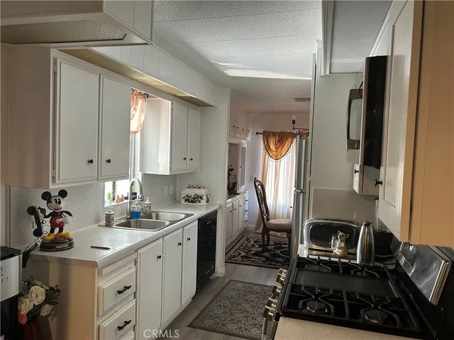 a kitchen with a sink stove and refrigerator