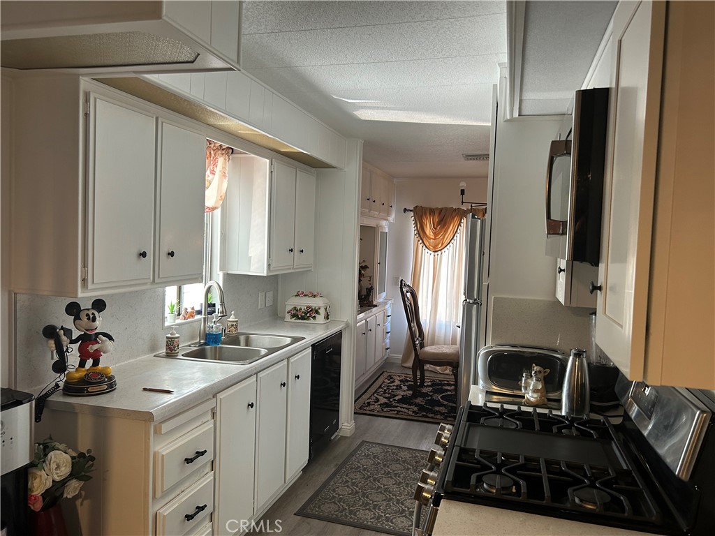 840 East Foothill Boulevard, Unit 144 Azusa, CA 91702 - Photo 2 of 6 a kitchen with a sink stove and refrigerator