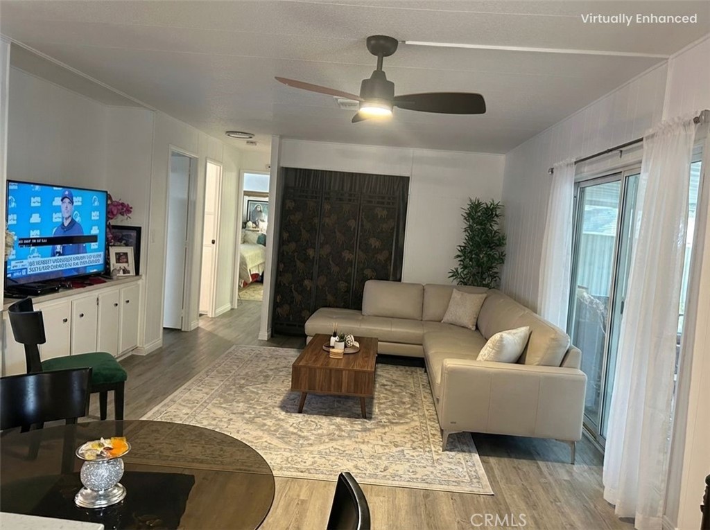 840 East Foothill Boulevard, Unit 144 Azusa, CA 91702 - Photo 5 of 6 a living room with furniture and a flat screen tv