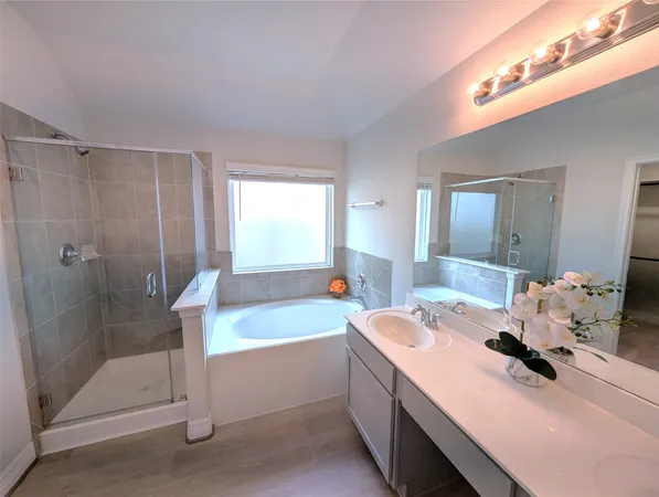 a bathroom with a tub sink and shower