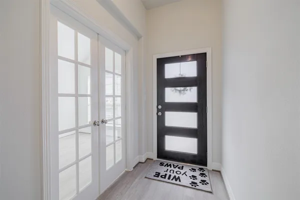 a view of room with window and wooden floor