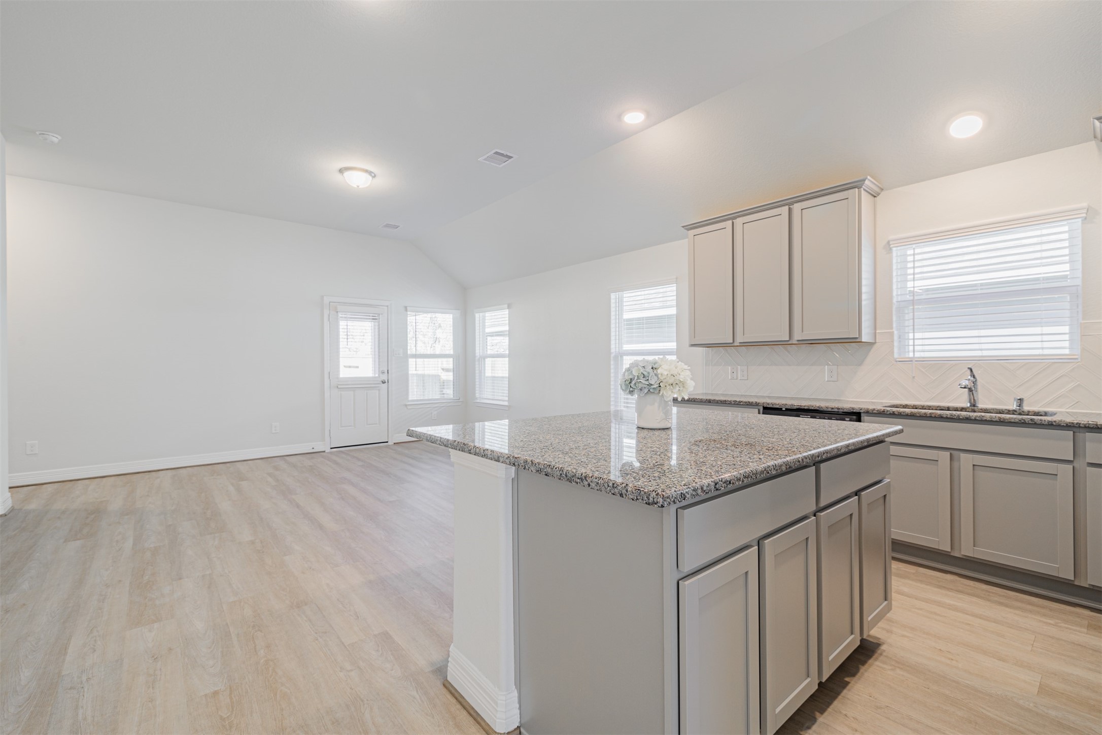 33118 School Hl Road Fulshear, TX 77441 - Photo 8 of 21 a kitchen that has a sink and a stove in it