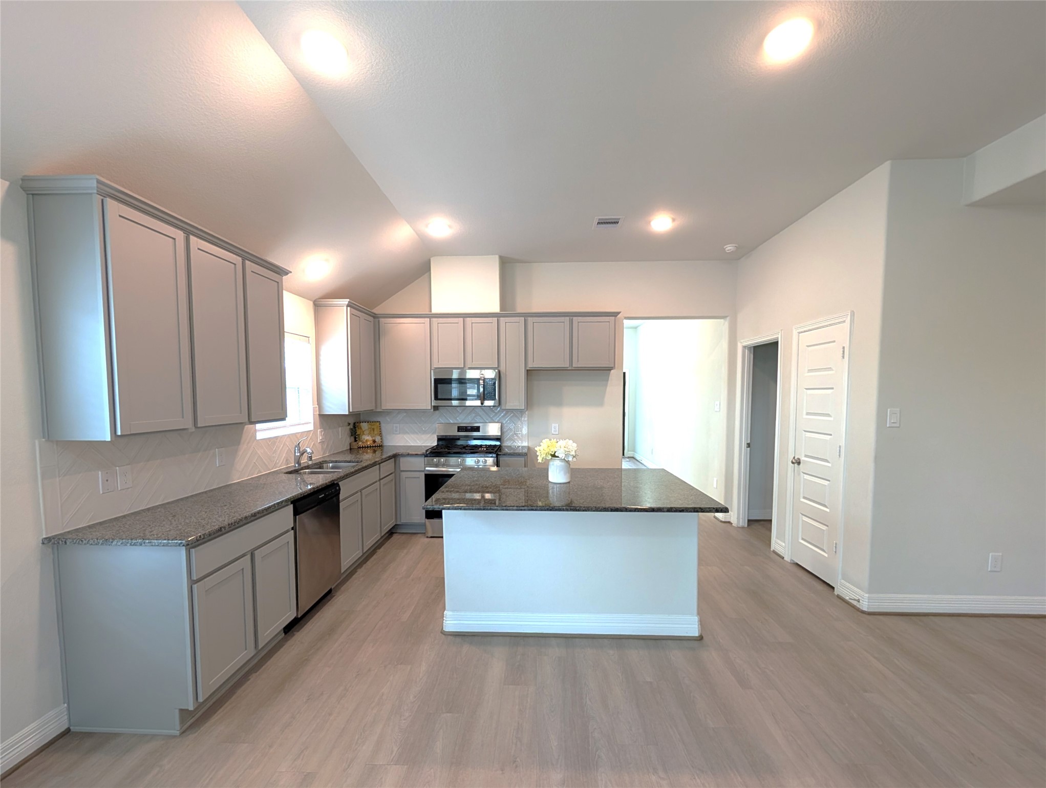 33118 School Hl Road Fulshear, TX 77441 - Photo 9 of 21 a kitchen with stainless steel appliances granite countertop a stove a sink and a refrigerator