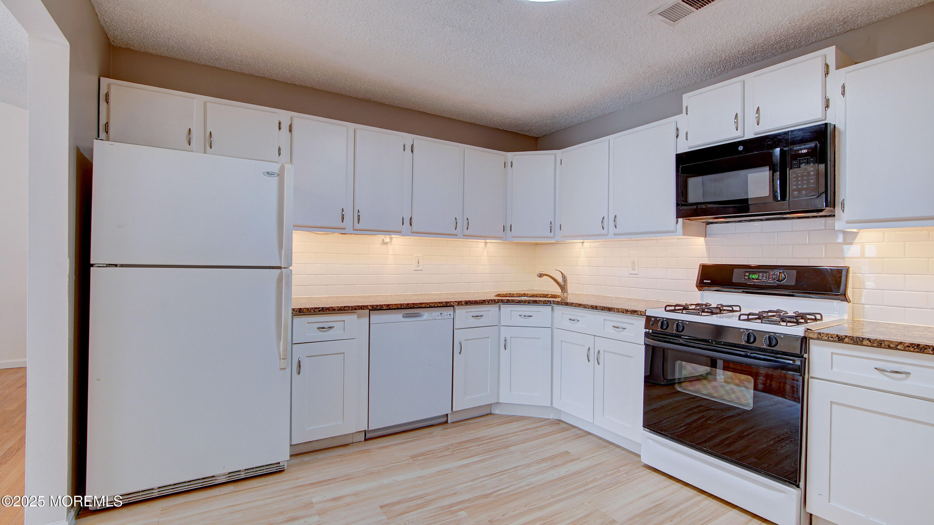 316 Tulip Lane Freehold, NJ 07728 - Photo 18 of 39 a kitchen with stainless steel appliances granite countertop a refrigerator stove a sink and a microwave