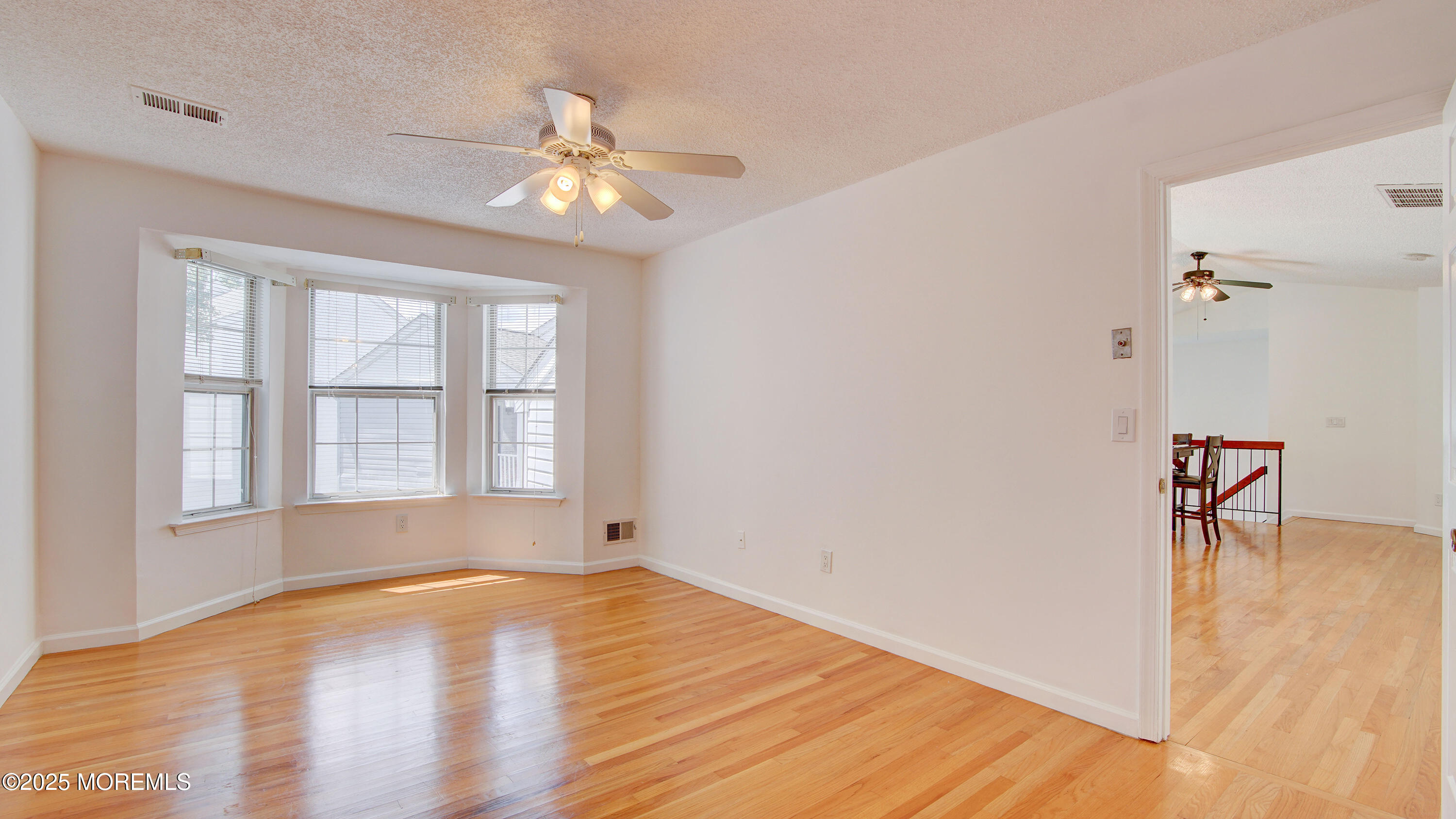 316 Tulip Lane Freehold, NJ 07728 - Photo 22 of 39 wooden floor in an empty room with a window