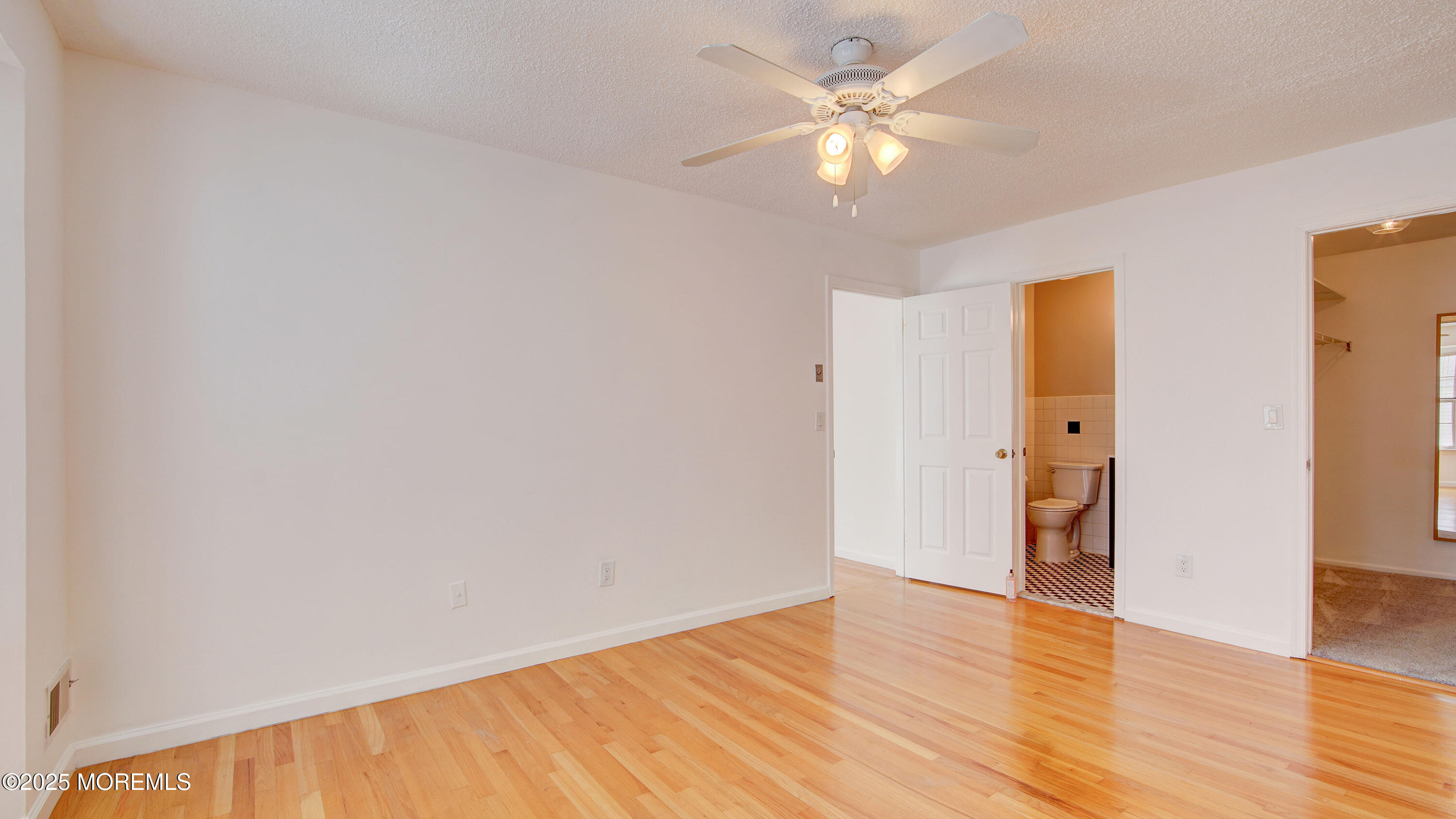 316 Tulip Lane Freehold, NJ 07728 - Photo 24 of 39 a view of an empty room with wooden floor