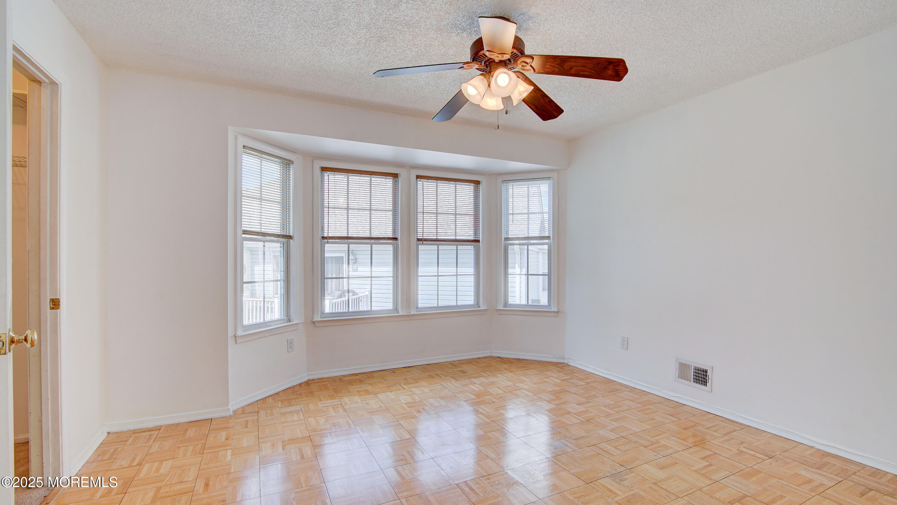 316 Tulip Lane Freehold, NJ 07728 - Photo 28 of 39 an empty room with windows and fan