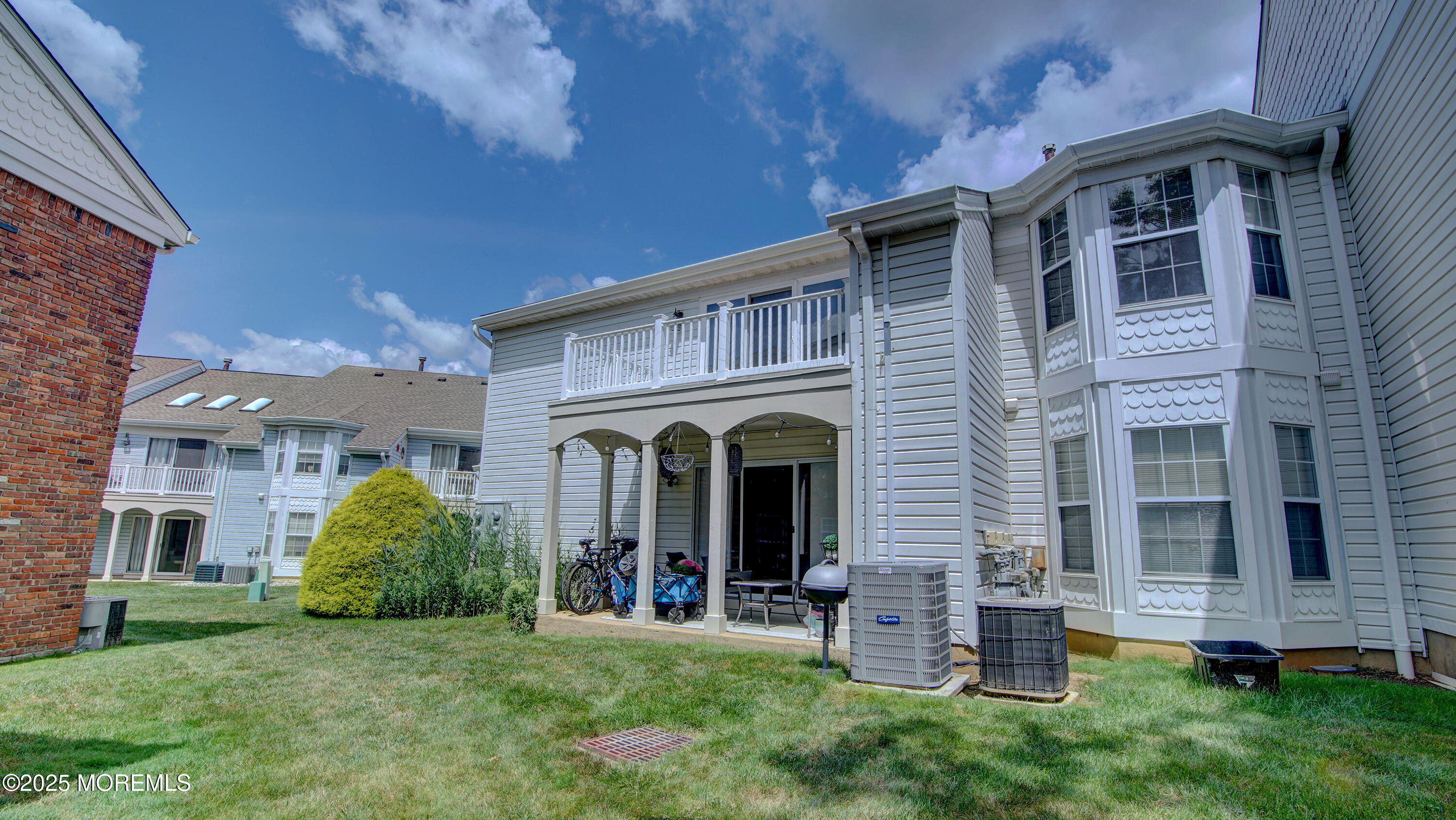 316 Tulip Lane Freehold, NJ 07728 - Photo 3 of 39 a view of a yard in front of a brick house