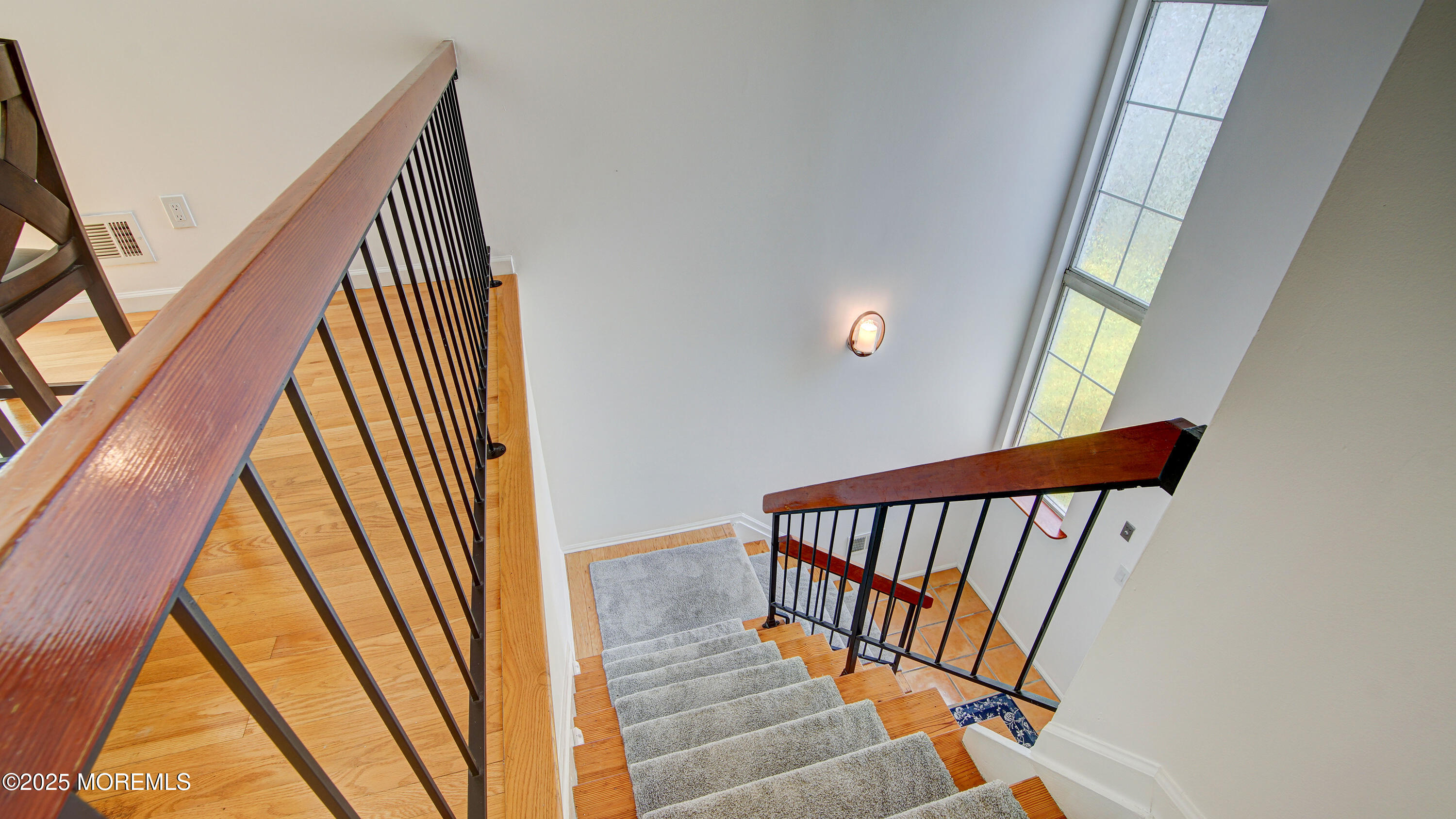 316 Tulip Lane Freehold, NJ 07728 - Photo 5 of 39 a view of staircase with railing and a floor to ceiling window