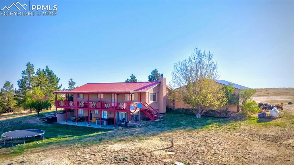 18560 Chelton Road Ramah, CO 80832 - Photo 30 of 34 a view of a house with a yard