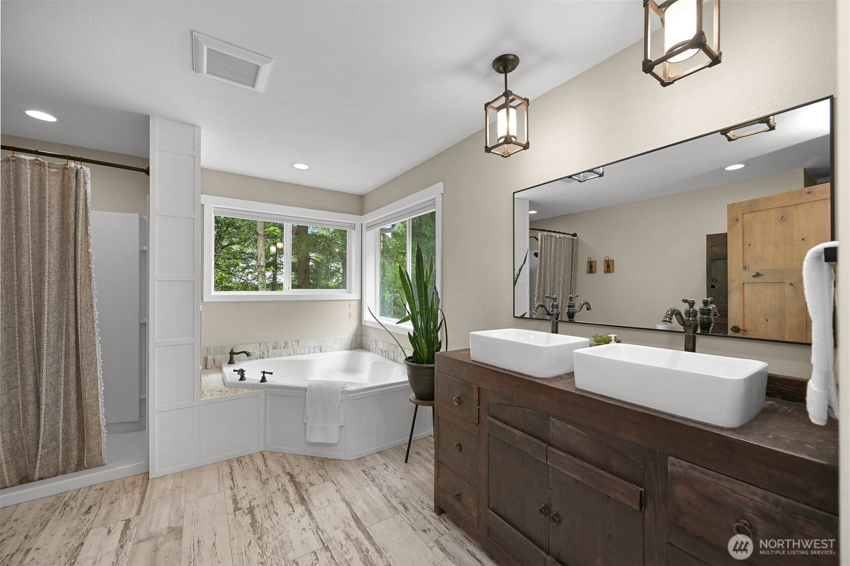 9111 Custer School Road Custer, WA 98240 - Photo 21 of 40 a spacious bathroom with a double vanity sink a mirror and a bathtub
