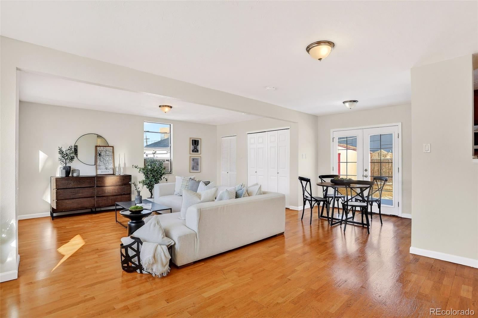 2836 South Grape Way Denver, CO 80222 - Photo 11 of 29 a living room with furniture and a wooden floor