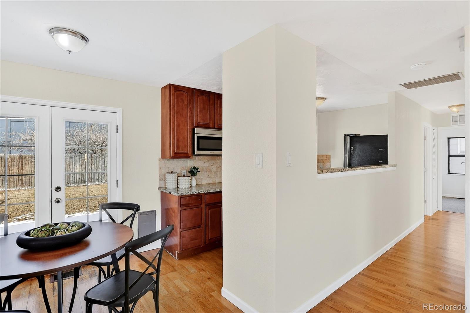 2836 South Grape Way Denver, CO 80222 - Photo 14 of 29 a view of a dining room with furniture and wooden floor