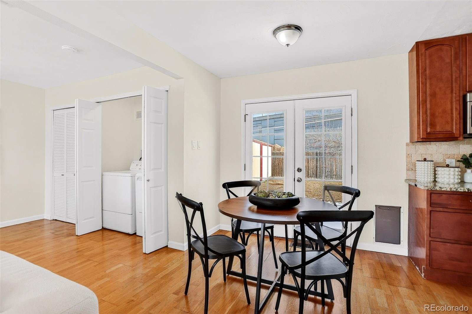 2836 South Grape Way Denver, CO 80222 - Photo 15 of 29 a dining room with furniture and wooden floor