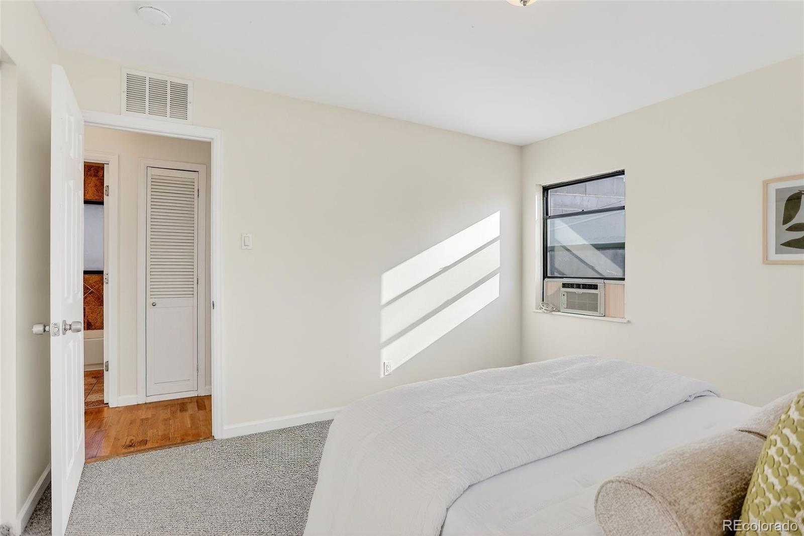 2836 South Grape Way Denver, CO 80222 - Photo 20 of 29 a bedroom with a bed and a window