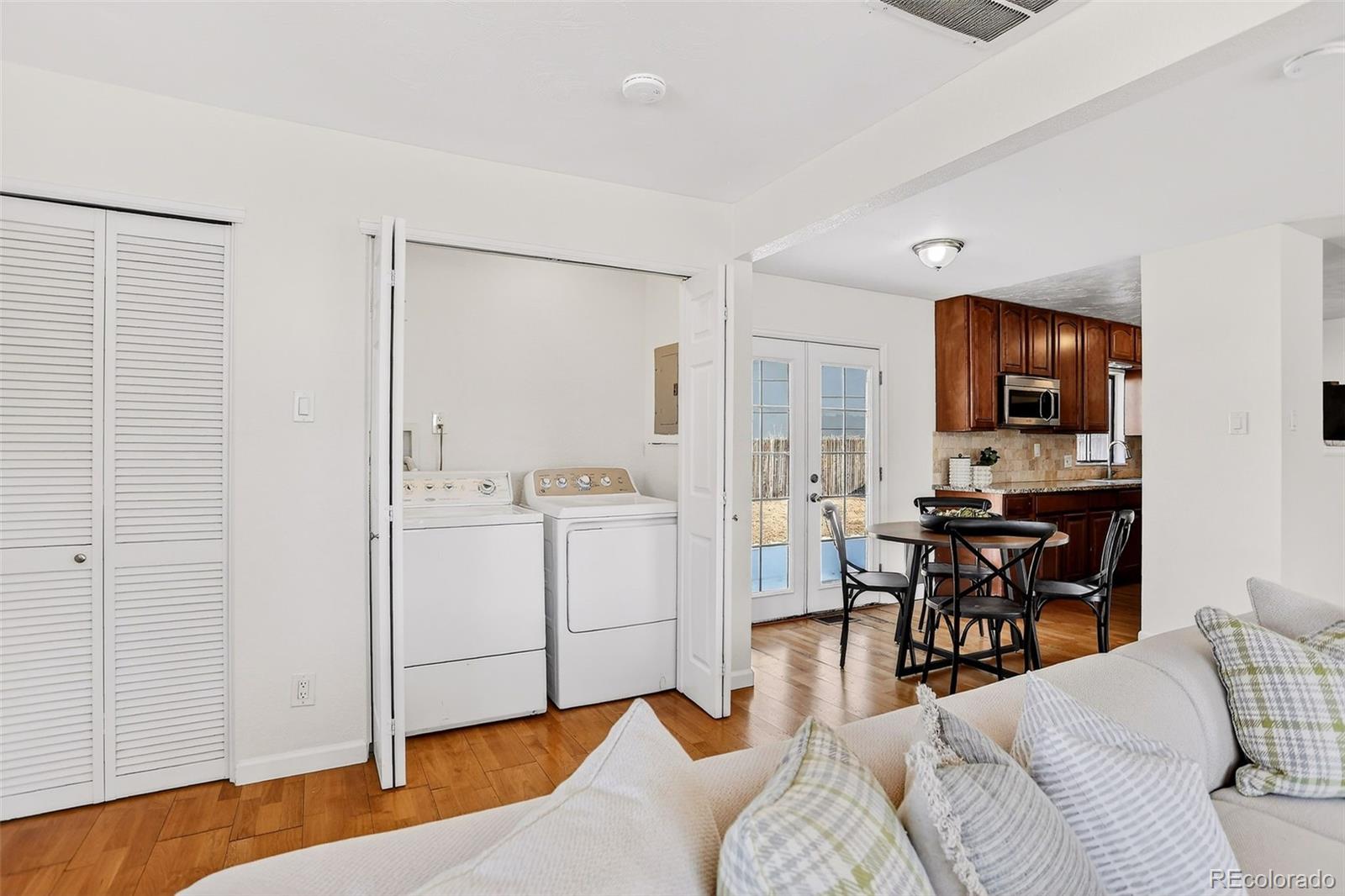 2836 South Grape Way Denver, CO 80222 - Photo 26 of 29 a living room with furniture and a view of kitchen