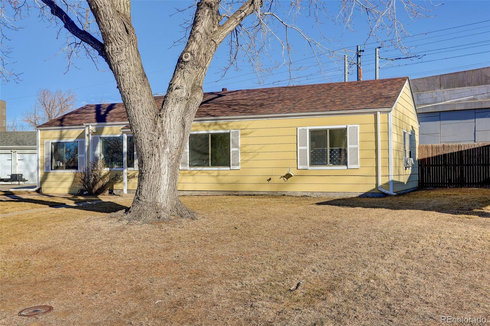 2836 South Grape Way Denver, CO 80222 - Photo 29 of 29 a house with trees in front of it