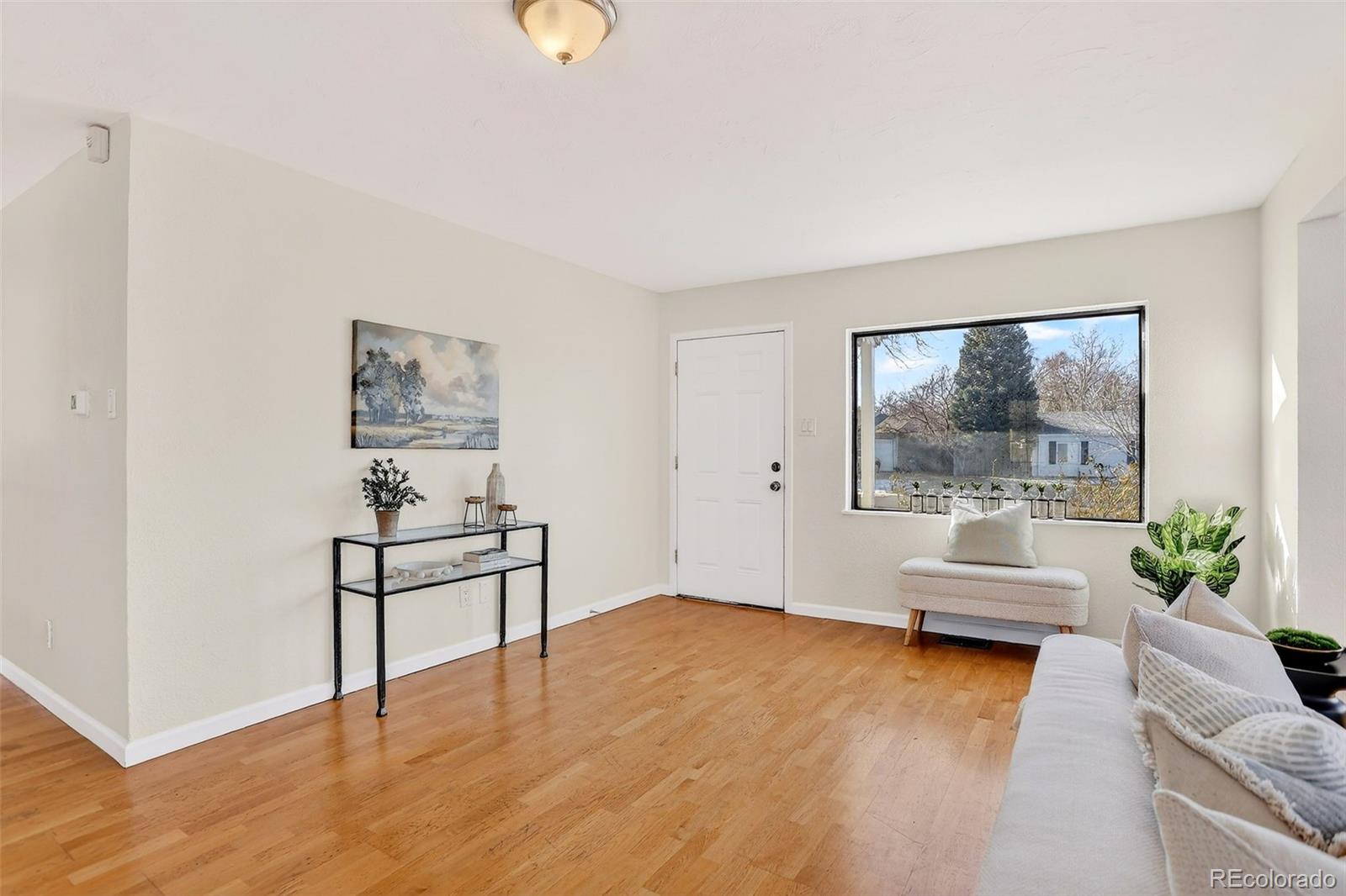 2836 South Grape Way Denver, CO 80222 - Photo 6 of 29 a living room with furniture and a large window