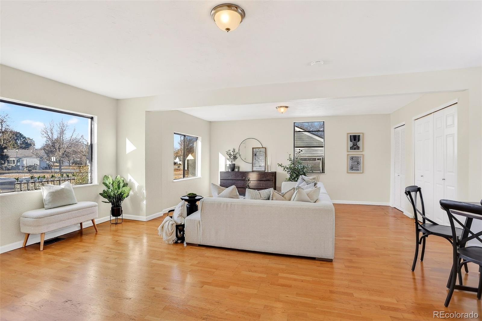 2836 South Grape Way Denver, CO 80222 - Photo 7 of 29 a living room with furniture and a large window