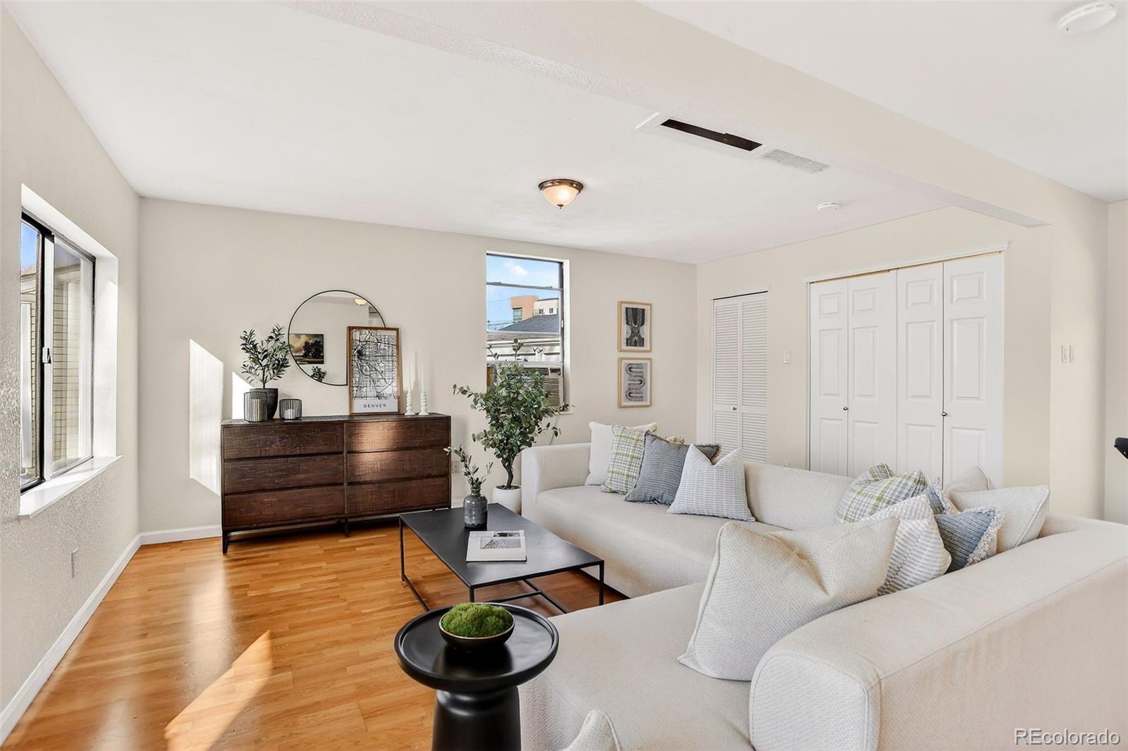 2836 South Grape Way Denver, CO 80222 - Photo 9 of 29 a living room with furniture and a wooden floor