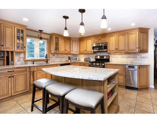 5 Anderson Drive Marshfield, MA 02050 - Photo 3 of 29 a kitchen with stainless steel appliances granite countertop a stove a sink a microwave a refrigerator and chairs