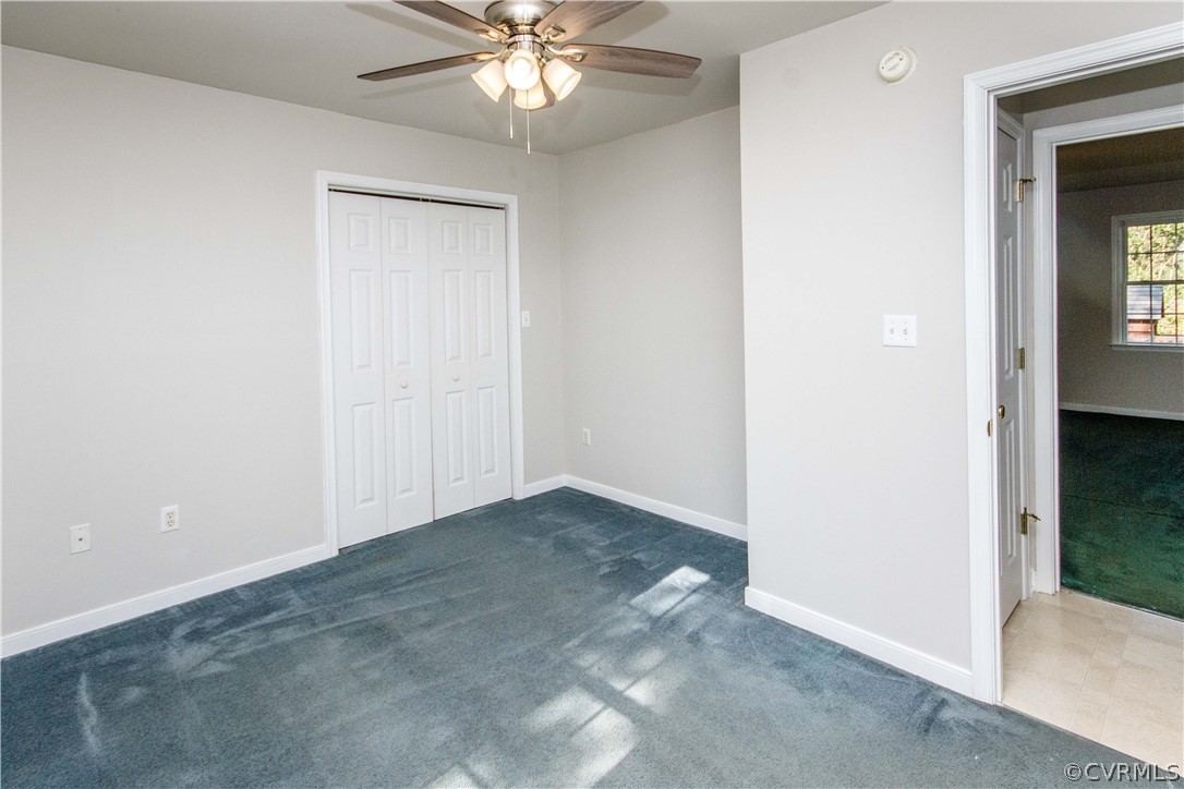 13743 Harrowgate Road Chester, VA 23831 - Photo 20 of 26 an empty room with closet and a chandelier fan