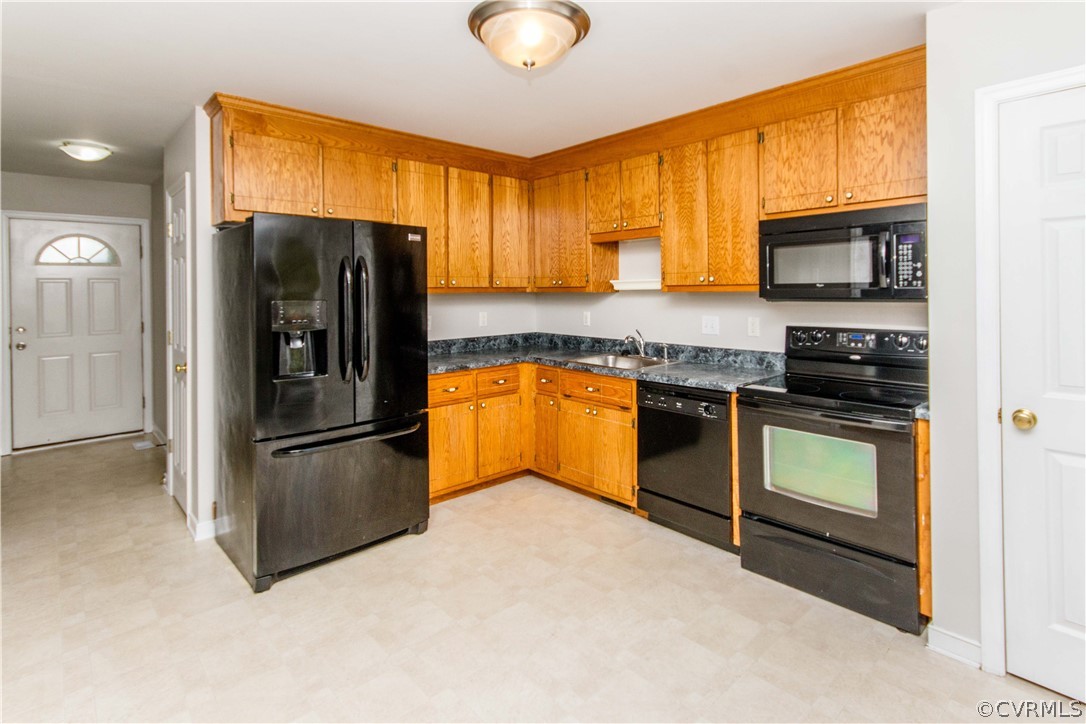 13743 Harrowgate Road Chester, VA 23831 - Photo 8 of 26 a kitchen with granite countertop stainless steel appliances a refrigerator sink and microwave