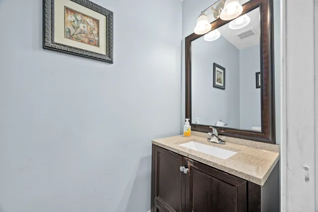 a bathroom with a sink vanity and a mirror