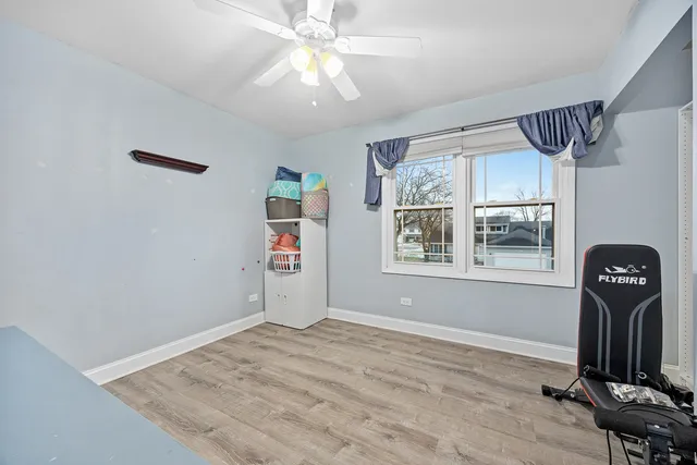 a view of a livingroom with wooden floor and a window