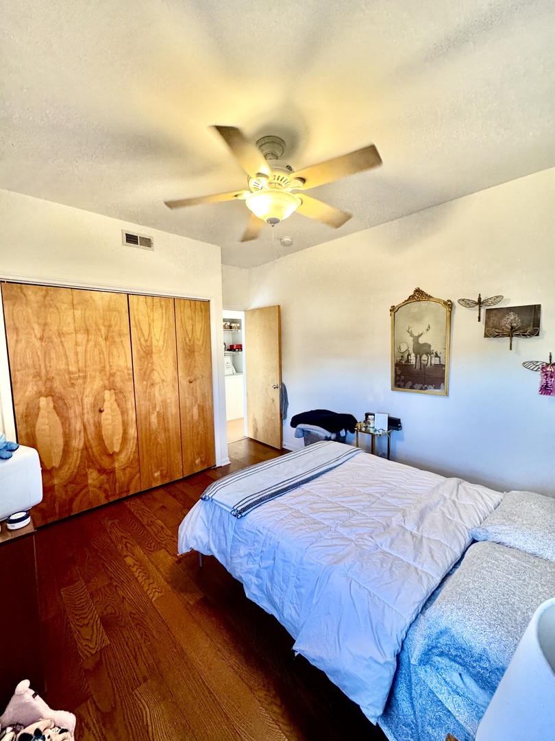 7349 Madison Street, Unit D Forest Park, IL 60130 - Photo 4 of 7 a bedroom with a bed and wooden floor