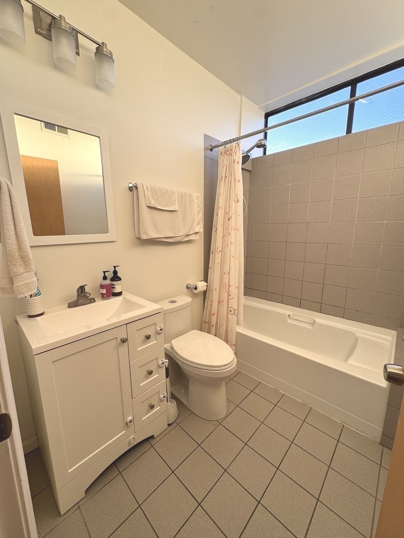 7349 Madison Street, Unit D Forest Park, IL 60130 - Photo 6 of 7 a bathroom with a sink a toilet and shower