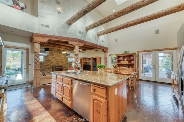 a kitchen with stainless steel appliances granite countertop a stove and cabinets
