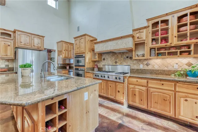 a kitchen with stainless steel appliances granite countertop a sink and a cabinets